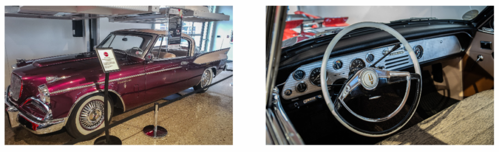 Photo of a red vintage luxury car on display.