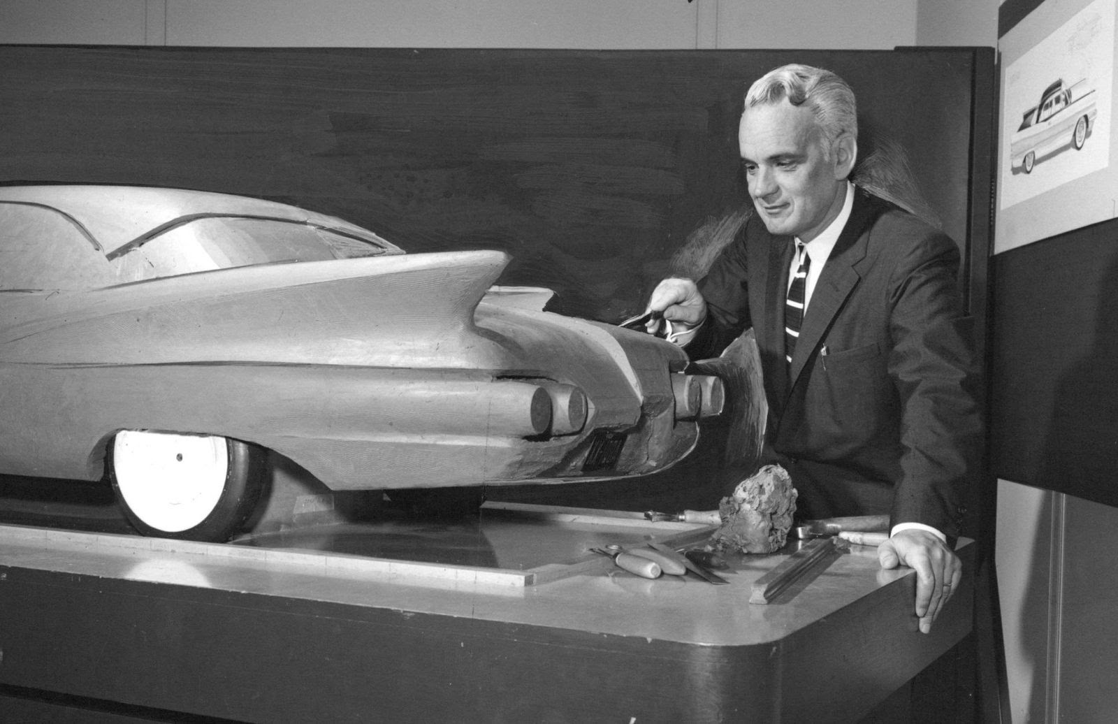 Explore the craftsmanship of a 1950s car model being sculpted by a designer, a peek into vintage auto design.