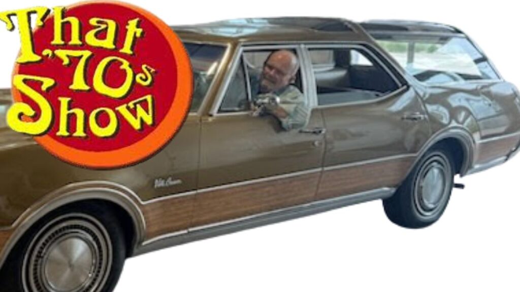 Kirkwood behind the wheel of the beloved Vista Cruiser from That 70's Show